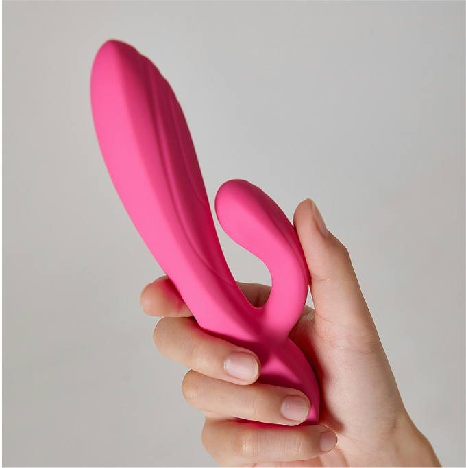 Self-care pleasure section image featuring a hand holding a pink dual-stimulator vibrator from Seductiva NZ