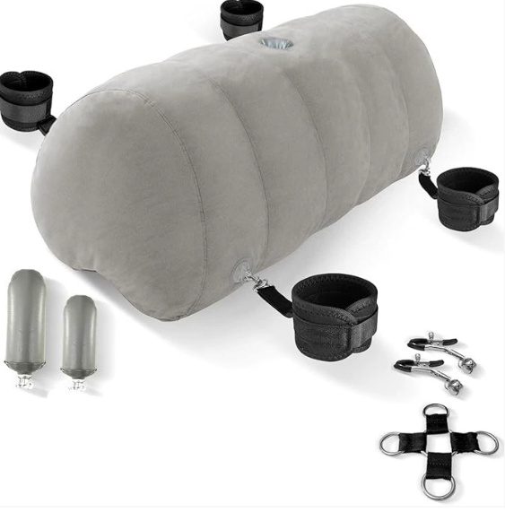 Heart-shaped inflatable sex pillow with dildo mount displayed