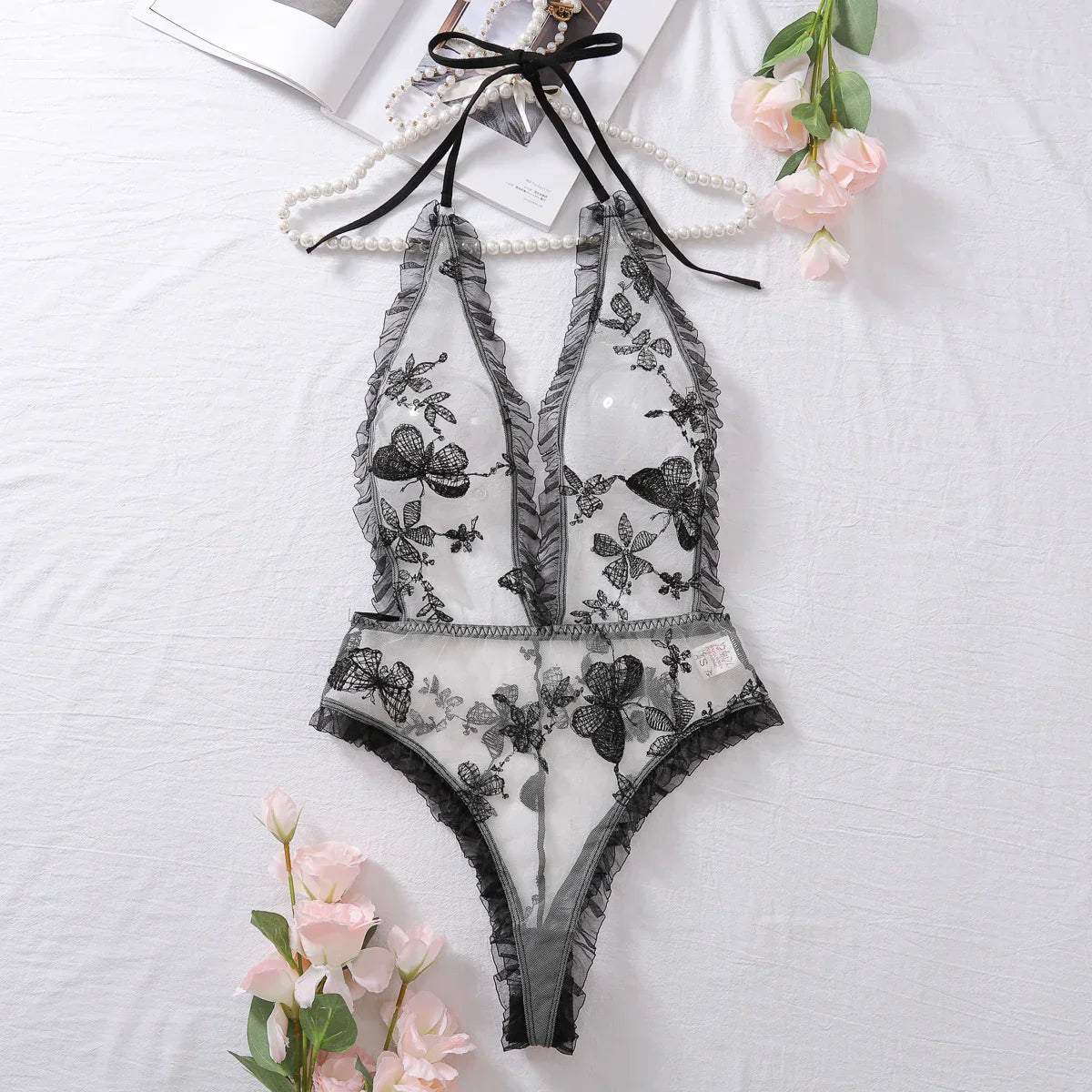 Model wearing teddy lingerie showing back strap design