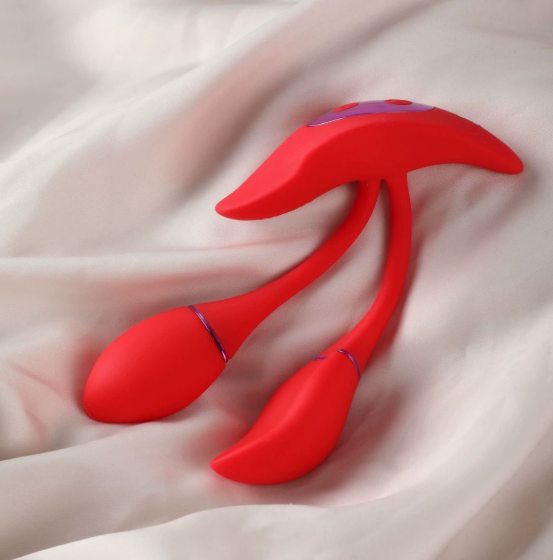 Fire Phoenix wearable couples vibrator — red body-safe silicone device on fabric (product lifestyle photo)