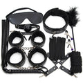 Black whip and restraints laid flat showcasing full set contents