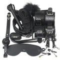 Leather restraints and flogger displayed with detailed stitching visible
