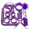 Complete leather BDSM kit arranged with whip, cuffs and collar visible