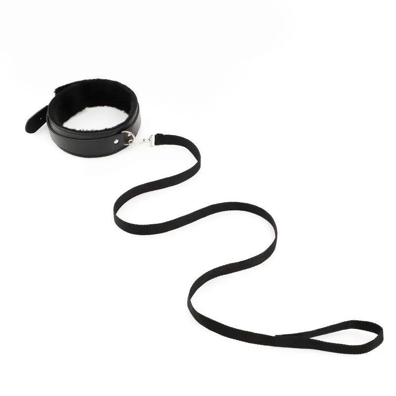 BDSM bondage kit with collar, cuffs and connecting chains arranged neatly