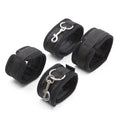 Bondage restraint cuffs shown with connecting straps and metal clips