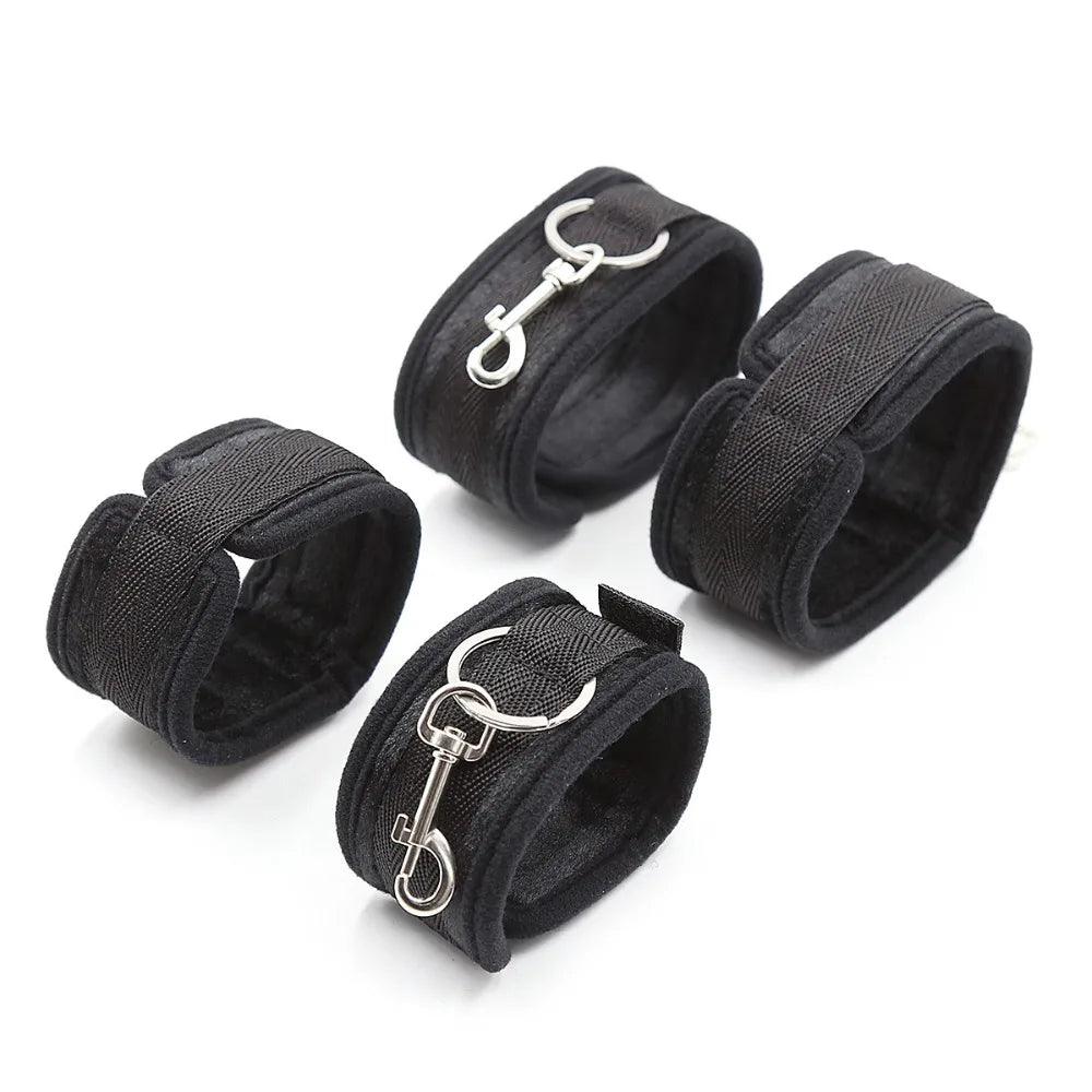 Bondage restraint cuffs shown with connecting straps and metal clips